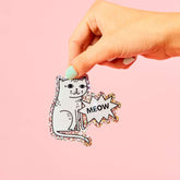 STRAYZ Katzen Glitzersticker "Meow" von einer Hand gehalten.